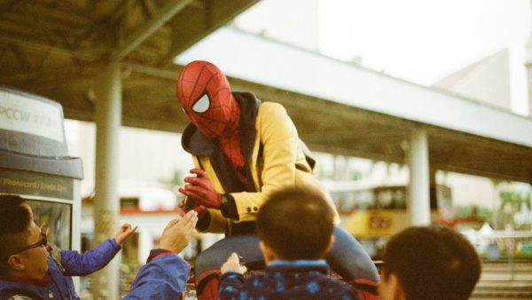 A man adding threads to a classic Spiderman costume